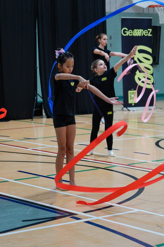 3 gymnasts training with rhythmic gymnastics ribbons 