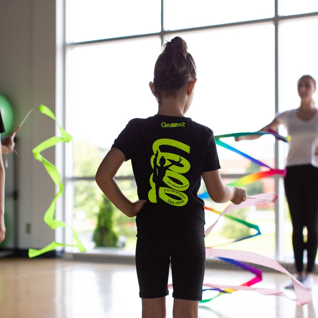 Gymnast with Ribbon showcasing Academy t-shirt