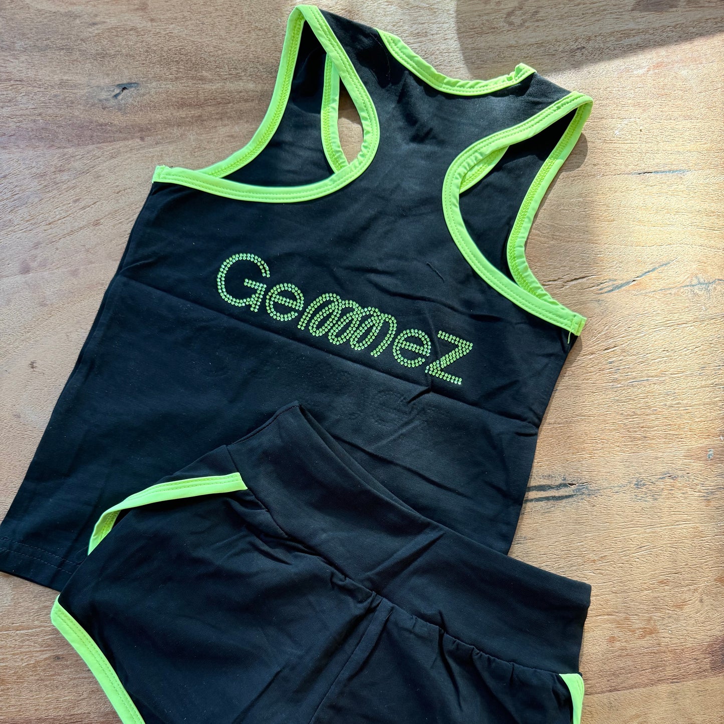 Black Gemmez brand rhinestones set showcasing the back of the tank top and shorts