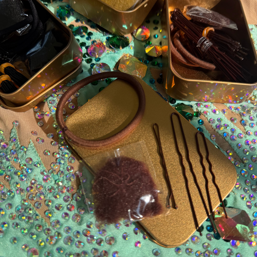 Set of hair accessories including bobby pins and a hairband on a glittery surface.