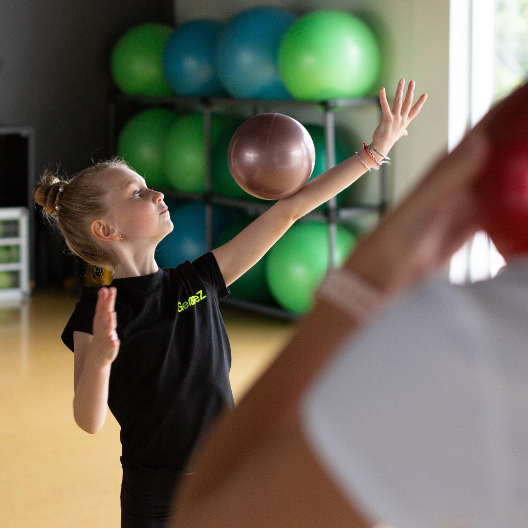 Gymnast rolling a ball on arm