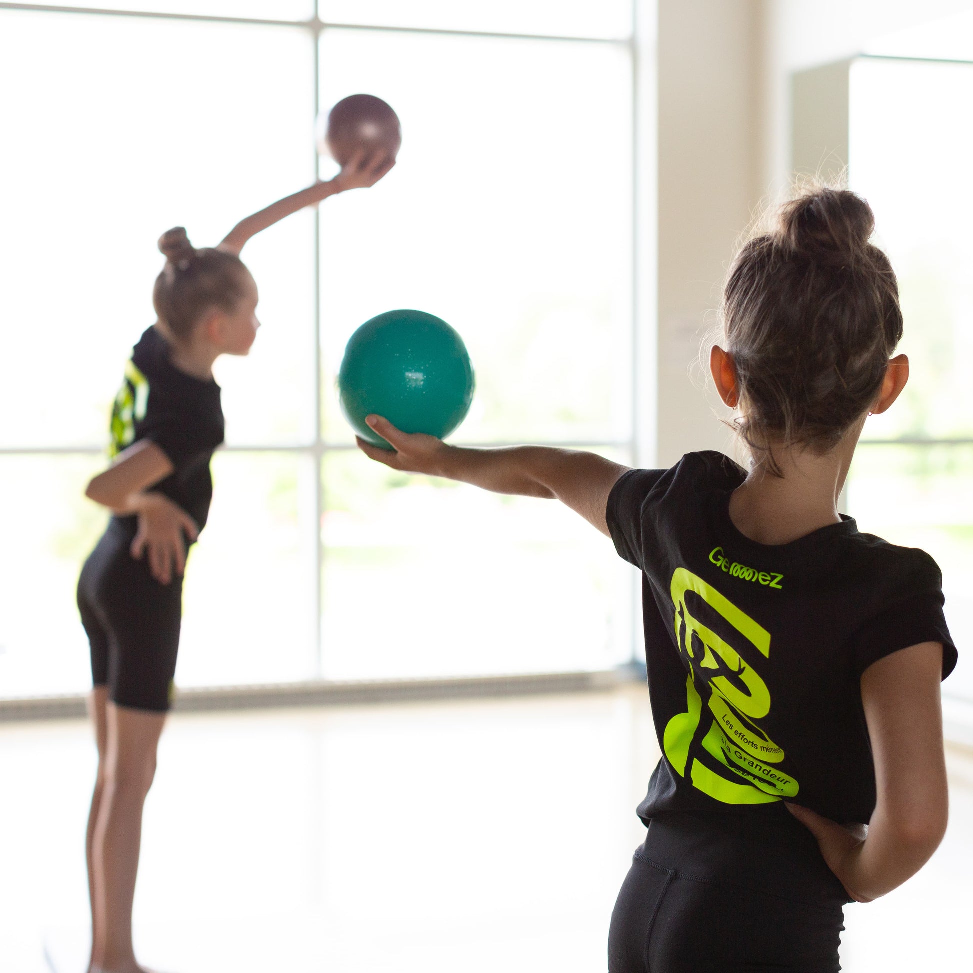 Gymnasts training with balls in Studio