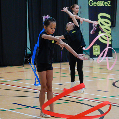 Gymnasts working with rayon ribbons wearing the Gemmez brand sportswear