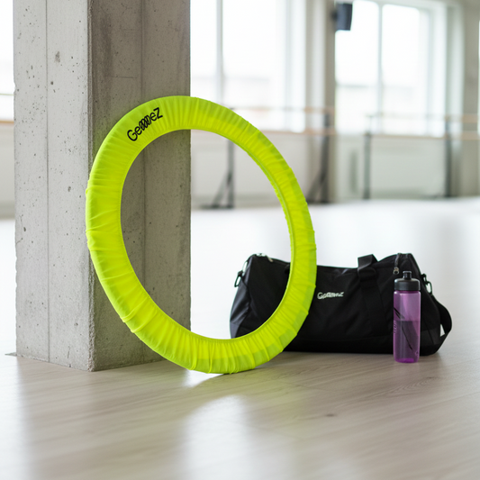 Neon Hoop cover on a concrete pole with a black bag and purple bottle in the background.