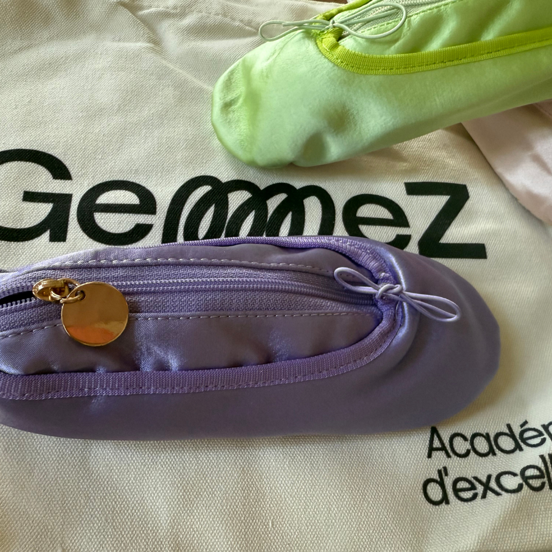 Purple and green shoe-shaped pouches on a bag surface with 'Gemmez' branding.