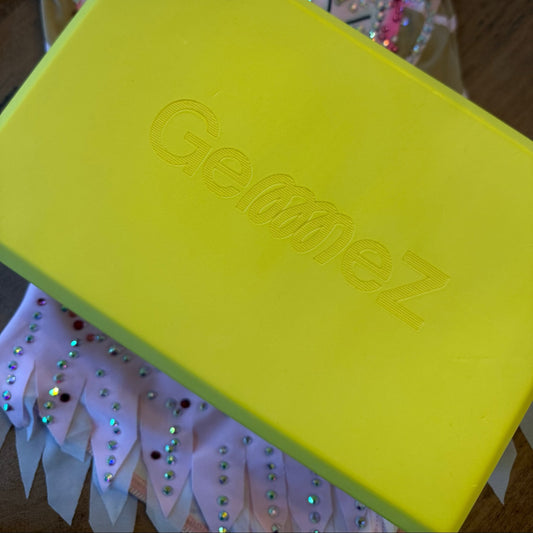 Yellow block with 'Gemez' branding on a decorative background